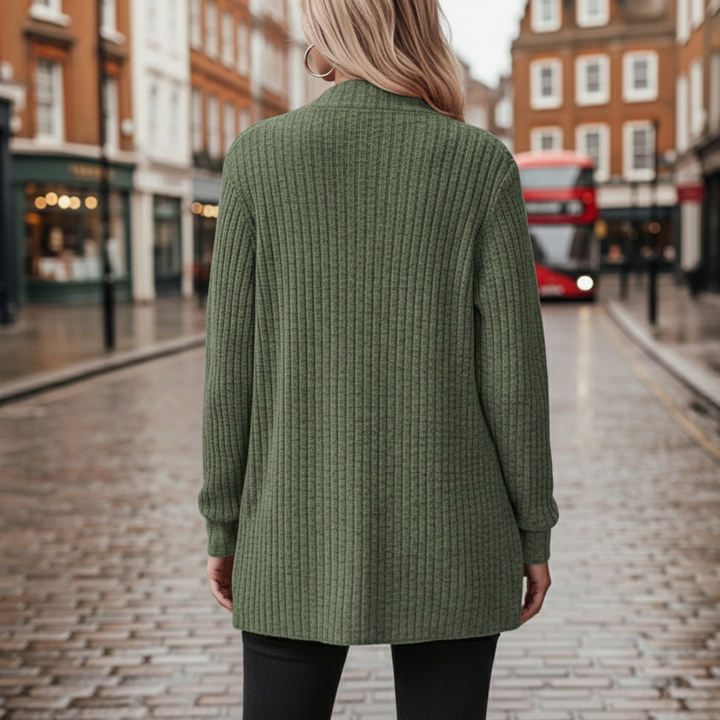 Back details of a woman wearing a green cardigan sweater, showcasing a cozy and stylish look for fall and winter.