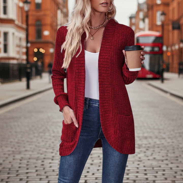  A woman in a red cardigan sweater, showcasing a cozy and stylish look for fall and winter.