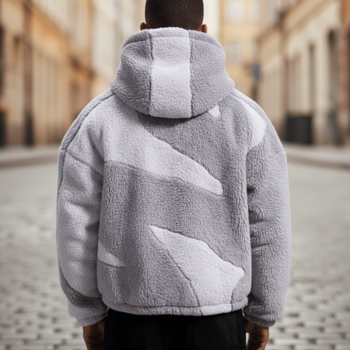  A man in a stylish grey and white fleece jacket with a hood