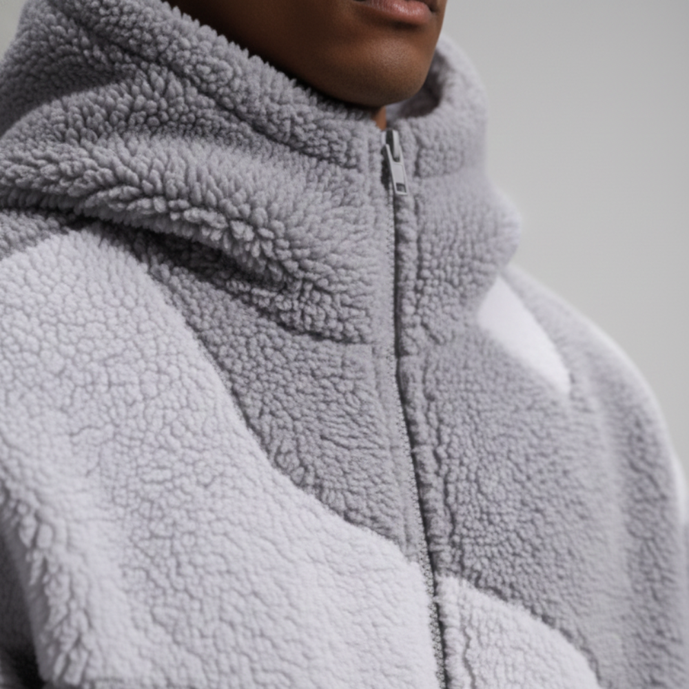  A man in a stylish grey and white fleece jacket with a hood