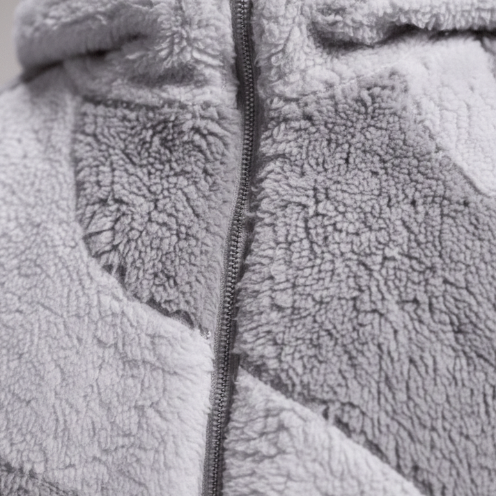  A man in a stylish grey and white fleece jacket with a hood