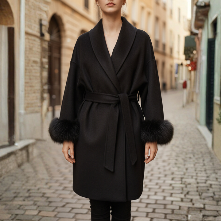A woman wearing a black belted coat, showcasing autumn elegance and style.