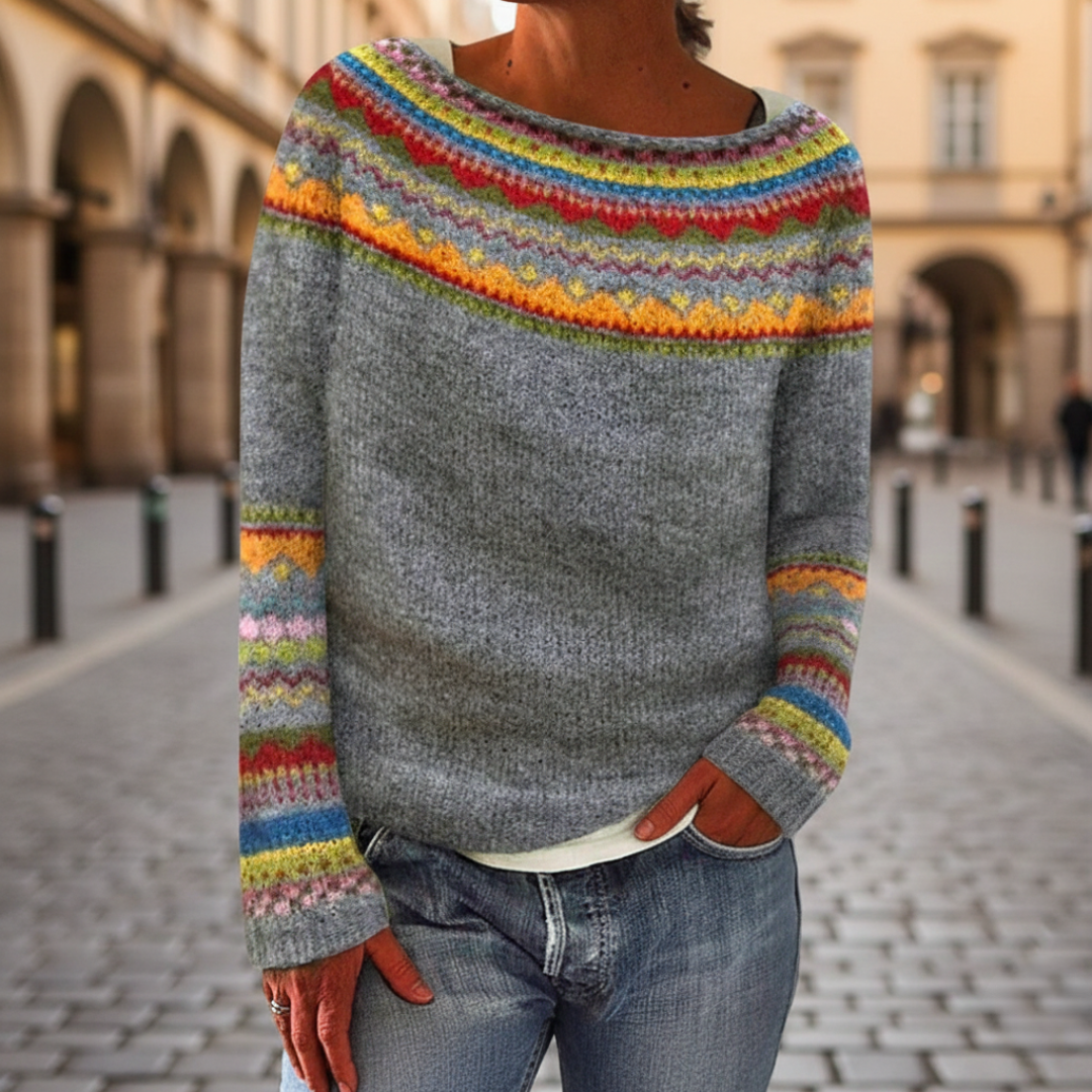 A woman in a colorful striped sweater with a boat neckline, fit for fall and winter.