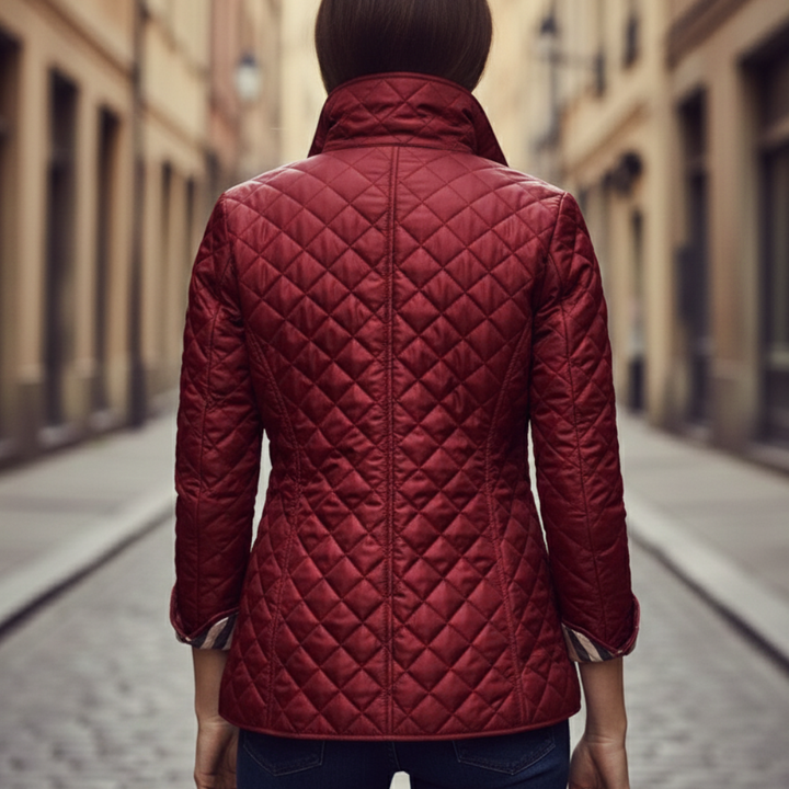 red quilted jacket featuring a check collar, ideal for transitional seasons.