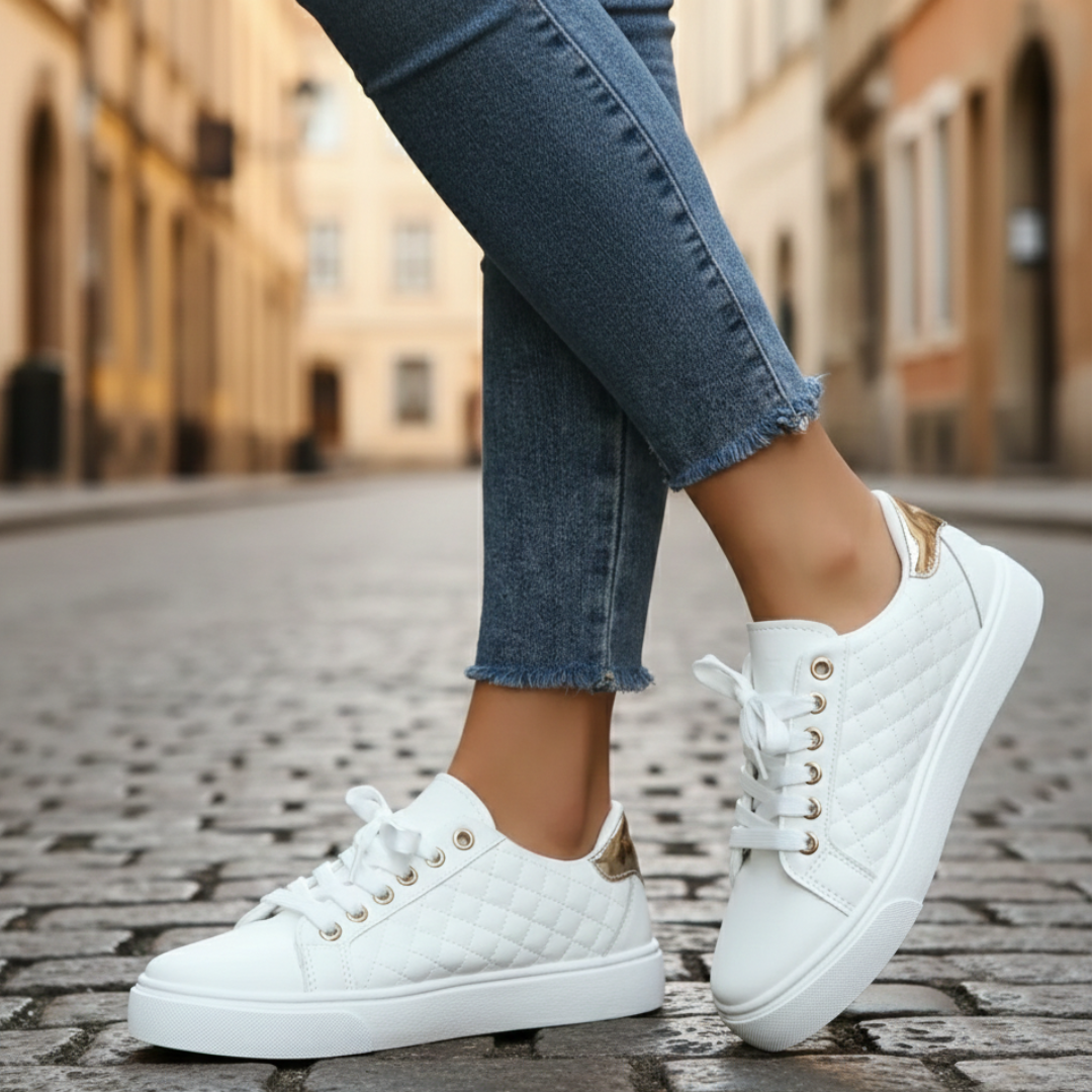 White sneakers with quilted texture and gold detailing, ideal for casual wear and comfort.
