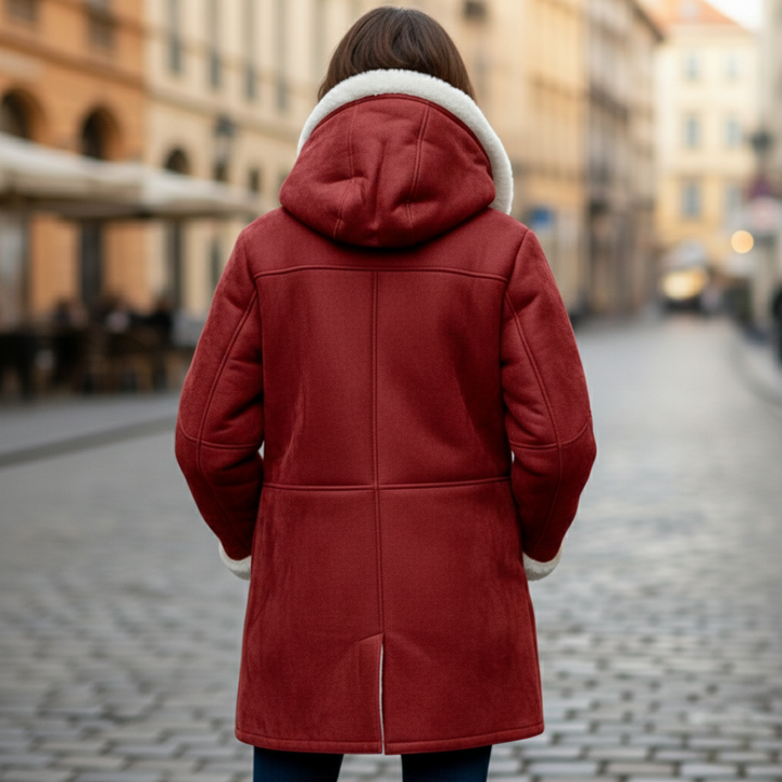 Red coat with white shearling, showcasing a cozy hood and toggle detailing, good for fall and winter.