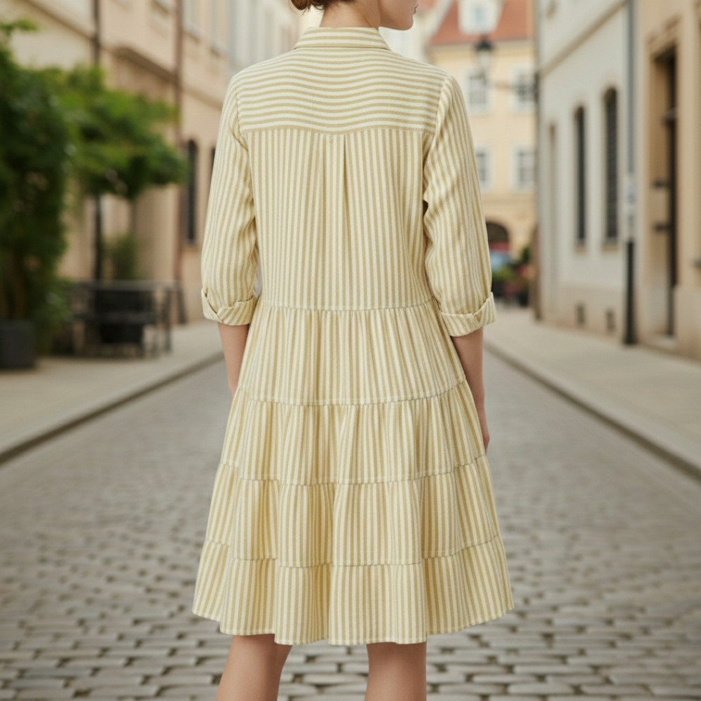  yellow striped shirt dress, back details with a turn-down collar and flowing skirt, ideal for casual gatherings in warm weather.