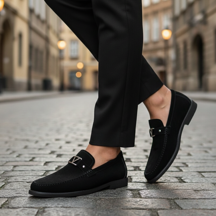 Men's black suede loafers with a gold buckle, featuring a smooth silhouette for a polished look.