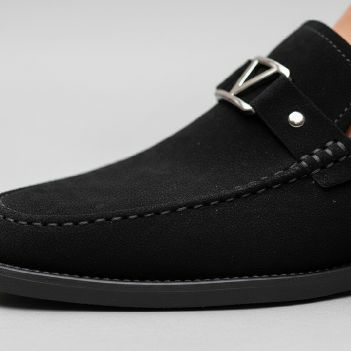 Close-up details of men's blue suede loafers with a gold buckle, featuring a smooth silhouette for a polished look.