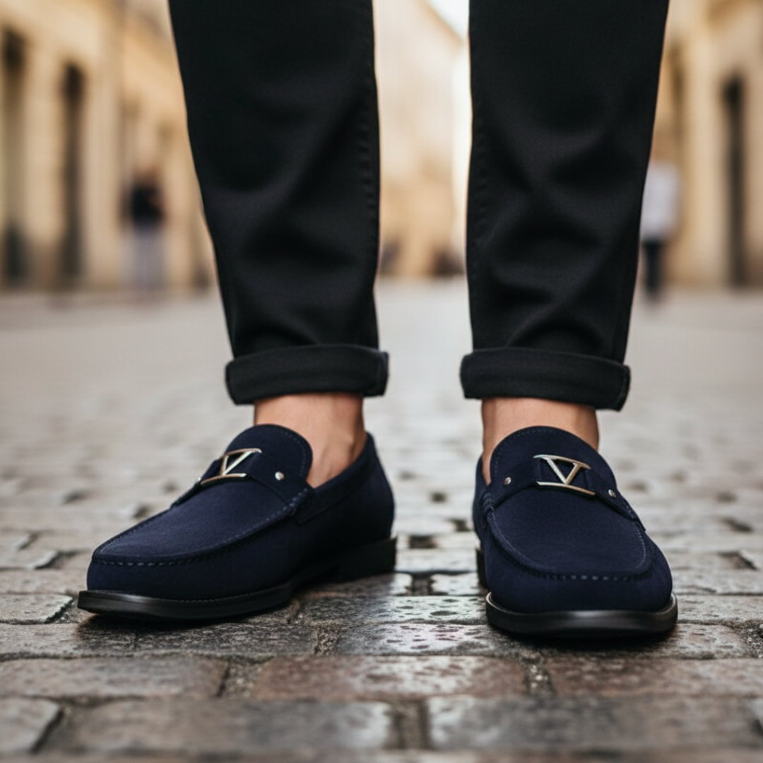 Men's blue suede loafers with a gold buckle, featuring a smooth silhouette for a polished look.
