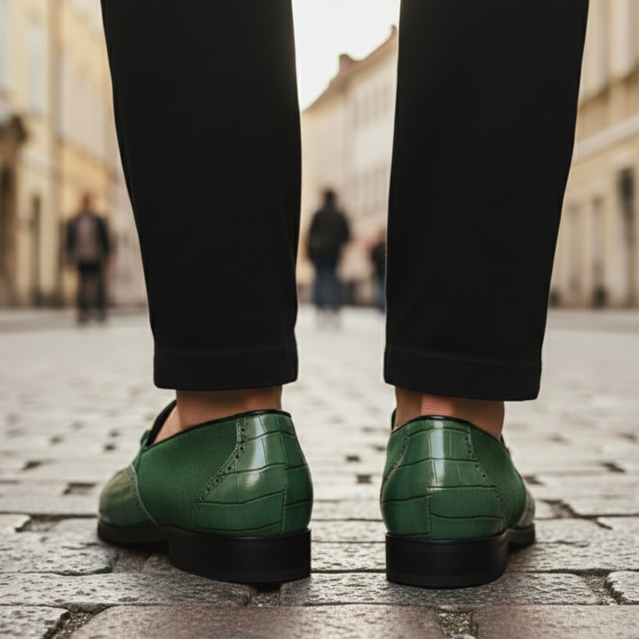 Green leather loafers with gold detailing, featuring a croc-embossed texture and square toe, ideal for formal occasions.

