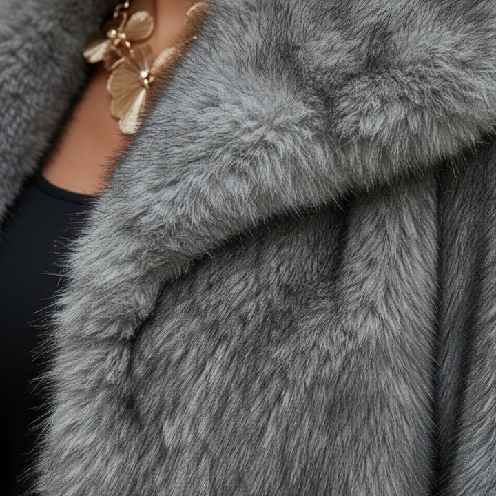 Close-up details of a grey faux fur jacket with a turn-down collar, showcasing a fit and hip-length design for fall and spring.
