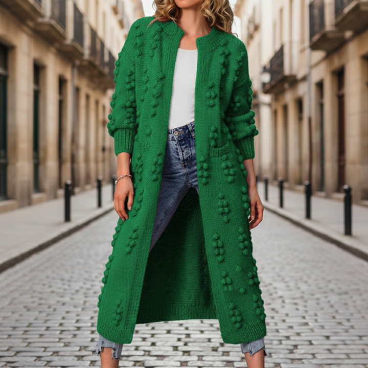 A woman in a green cardigan, embodying with a soft, open-front duster for fall and winter.
