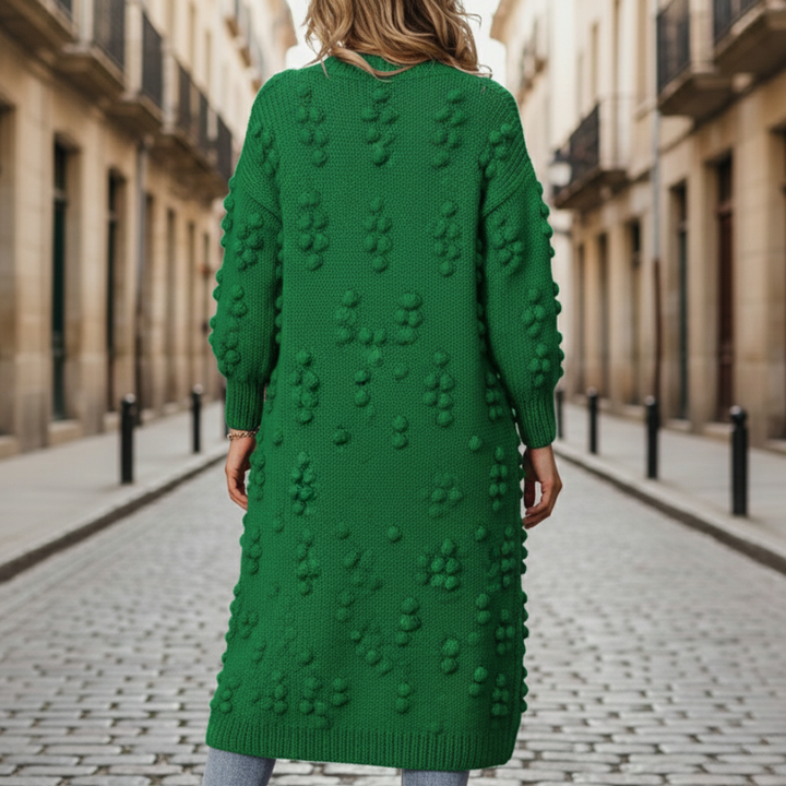 Back details of a woman in a green cardigan, embodying with a soft, open-front duster for fall and winter.
