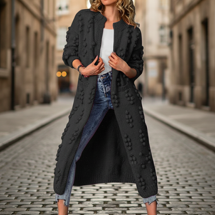 A woman in a black cardigan, embodying with a soft, open-front duster for fall and winter.