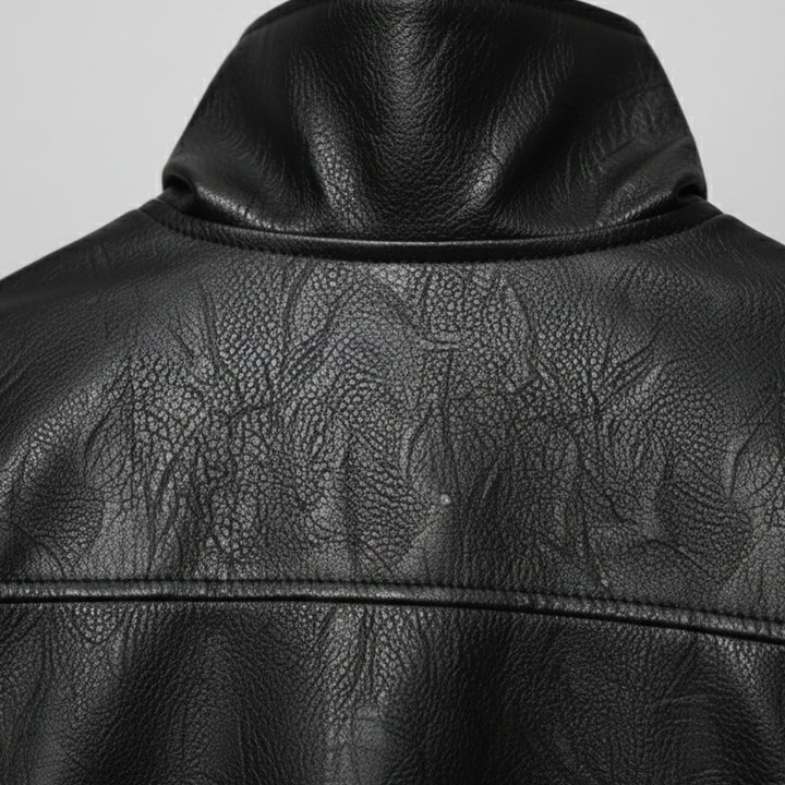 Black leather jacket with a front zipper, high stand collar, and long sleeves, designed for a modern, polished look.