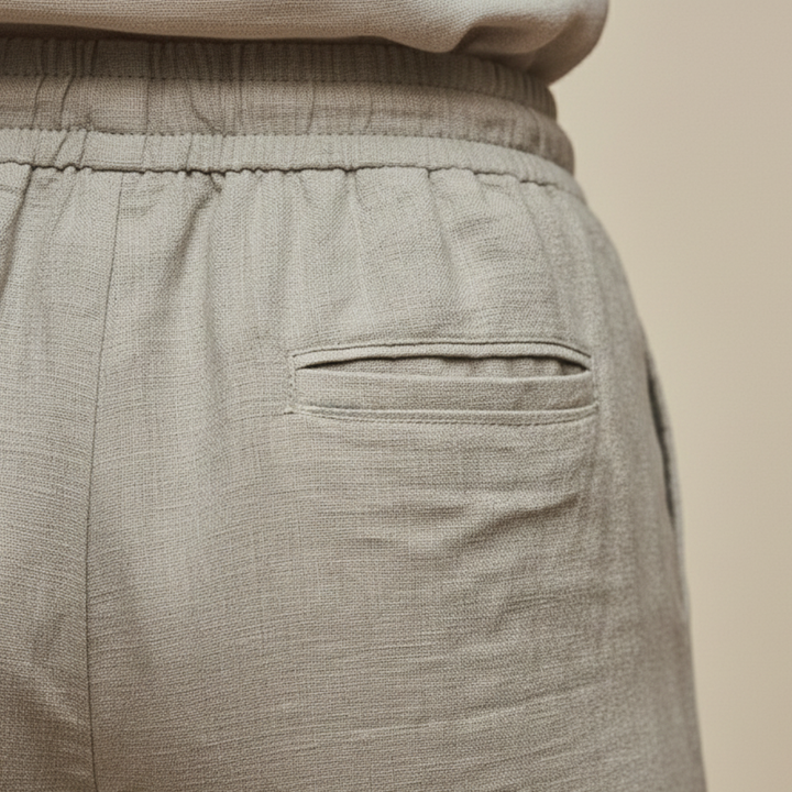 Khaki linen trousers, featuring a pull-on waist and straight-leg design for casual outfits. 