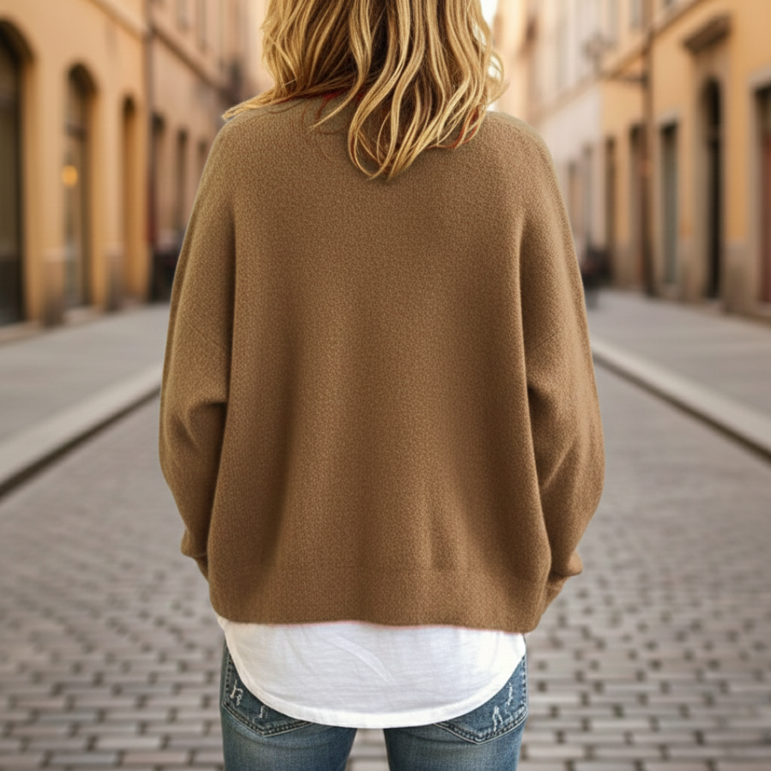 A woman in a beige cardigan sweater, with button-front, showcasing the long sleeves and V-neck, good for fall and spring layering.