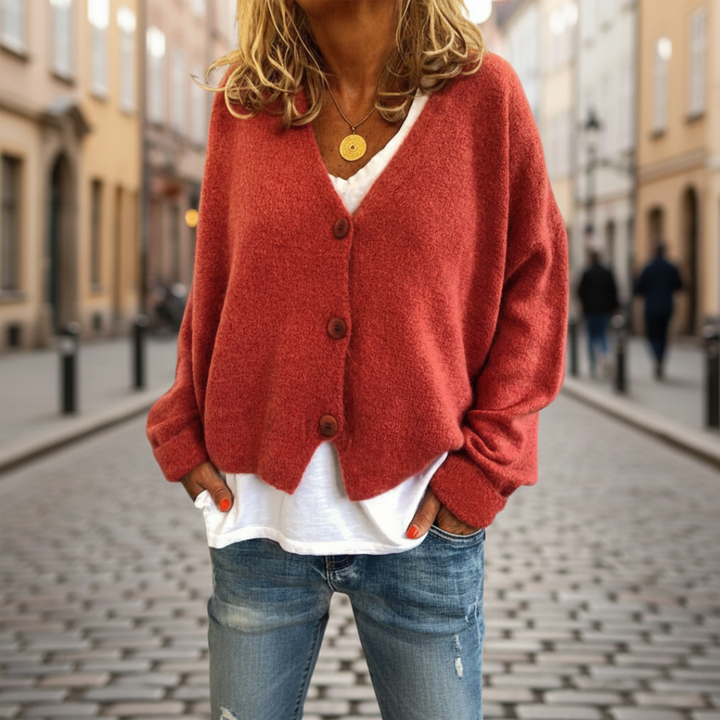  A woman in a red cardigan sweater, with button-front, showcasing the long sleeves and V-neck, good for fall and spring layering.