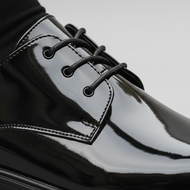 close up details of a black suit and polished black shoes, it shows elegance for formal occasions.