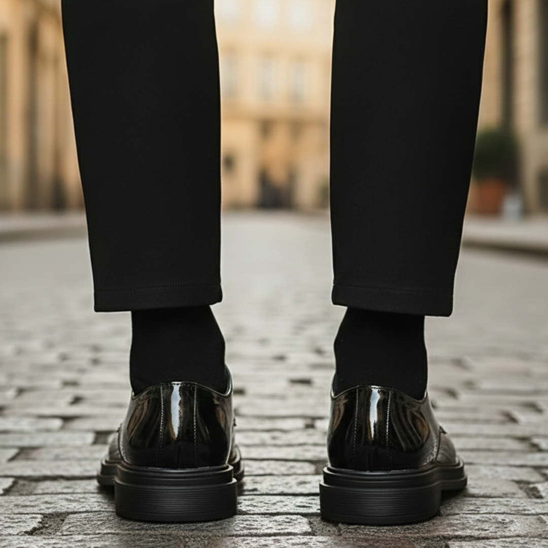 A man in a black suit and polished black shoes, it shows elegance for formal occasions.