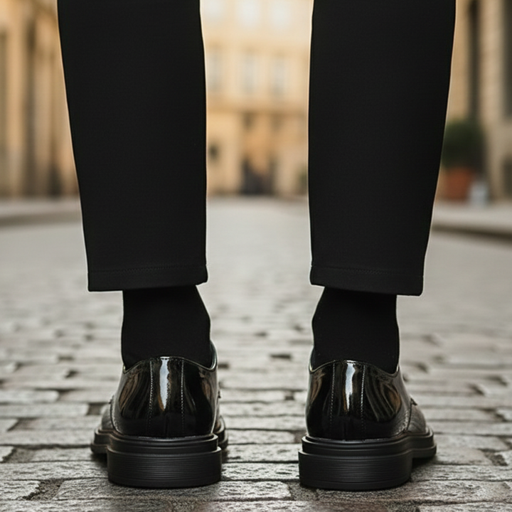 A man in a black suit and polished black shoes, it shows elegance for formal occasions.