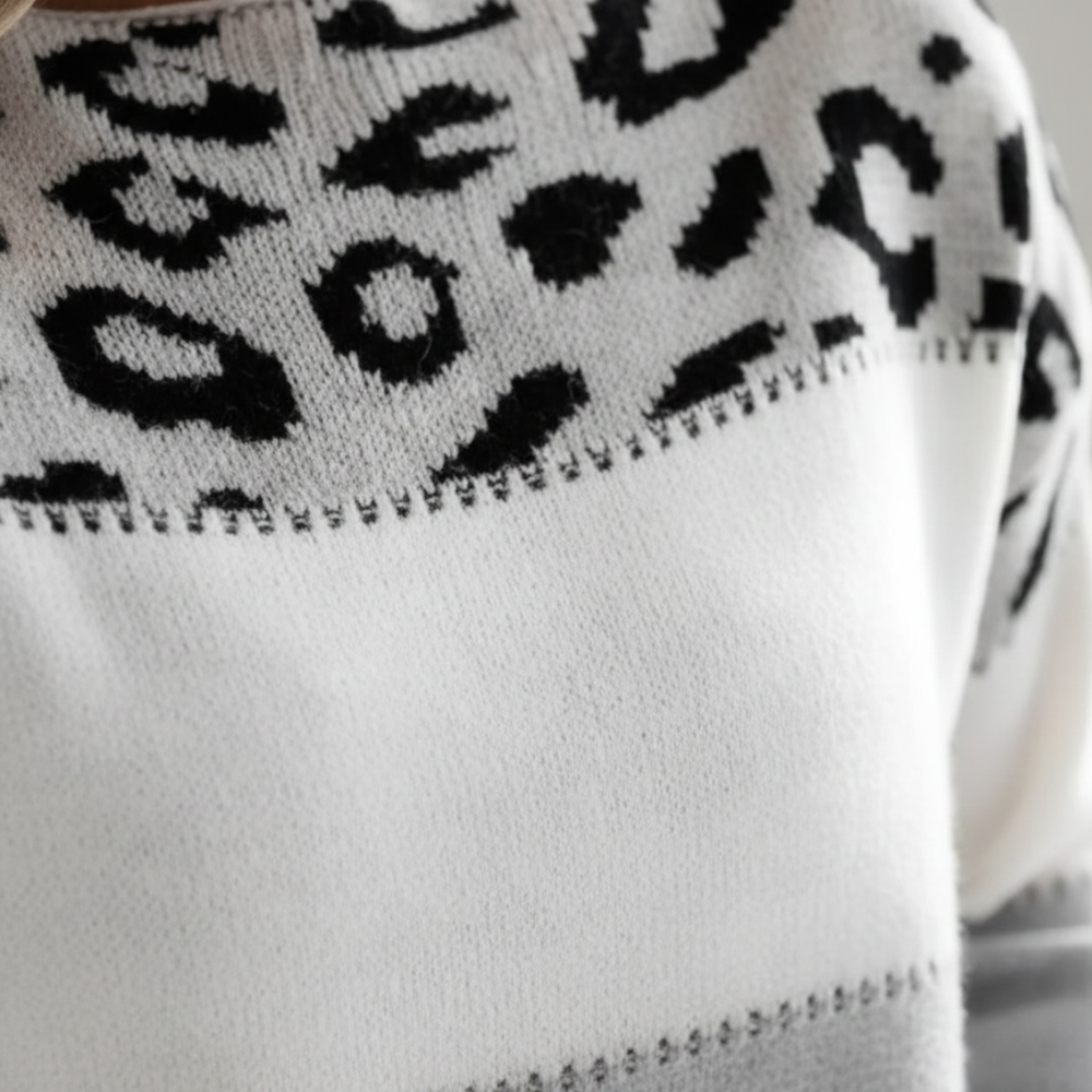 leopard print color block sweater with a round neckline and long sleeves, designed for comfort in cooler months.