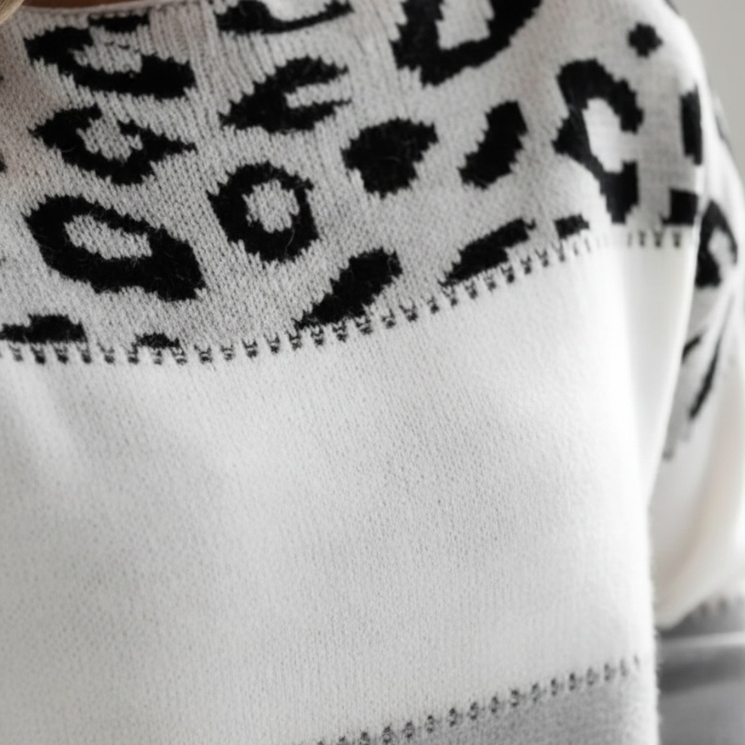 leopard print color block sweater with a round neckline and long sleeves, designed for comfort in cooler months.