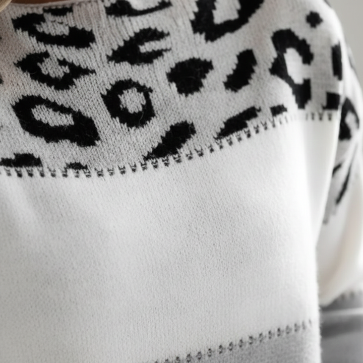 leopard print color block sweater with a round neckline and long sleeves, designed for comfort in cooler months.