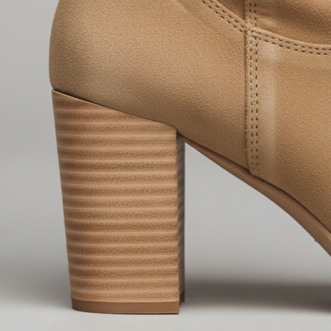 Brown knee-high boots with a side zipper, showcasing modern sophistication and a chunky block heel.