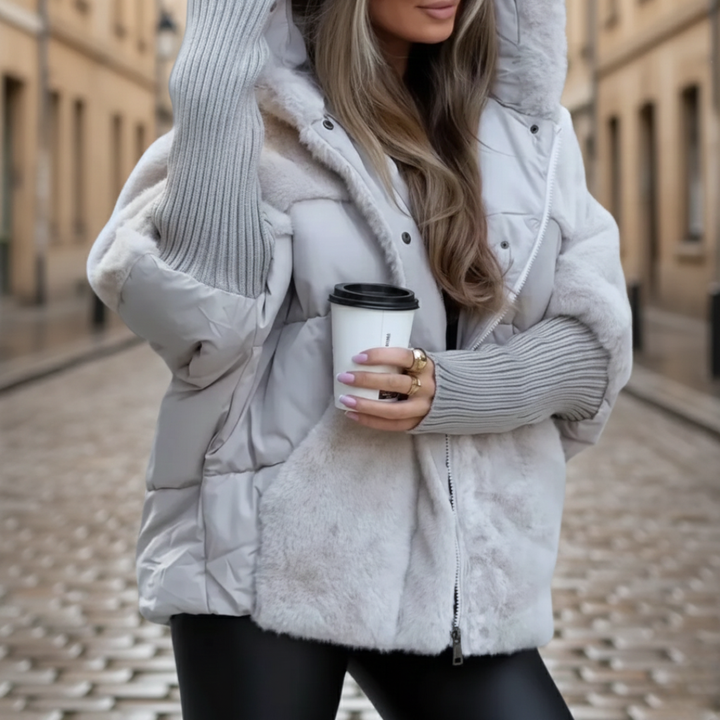 A woman wearing a grey coat, showcasing a stylish winter outfit suitable for cooler weather.