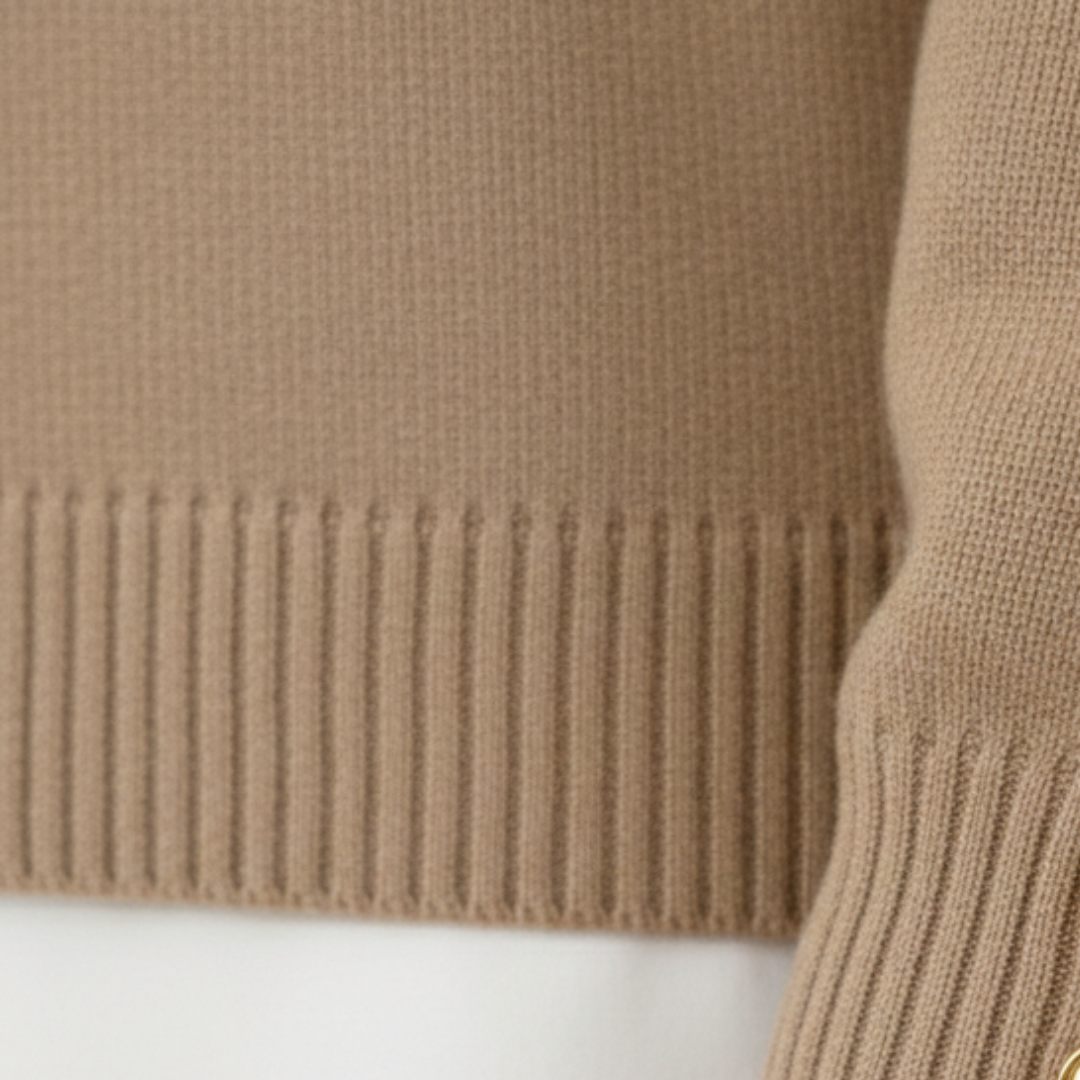 Coordinated beige sweater and pants set featuring gold-tone buttons.