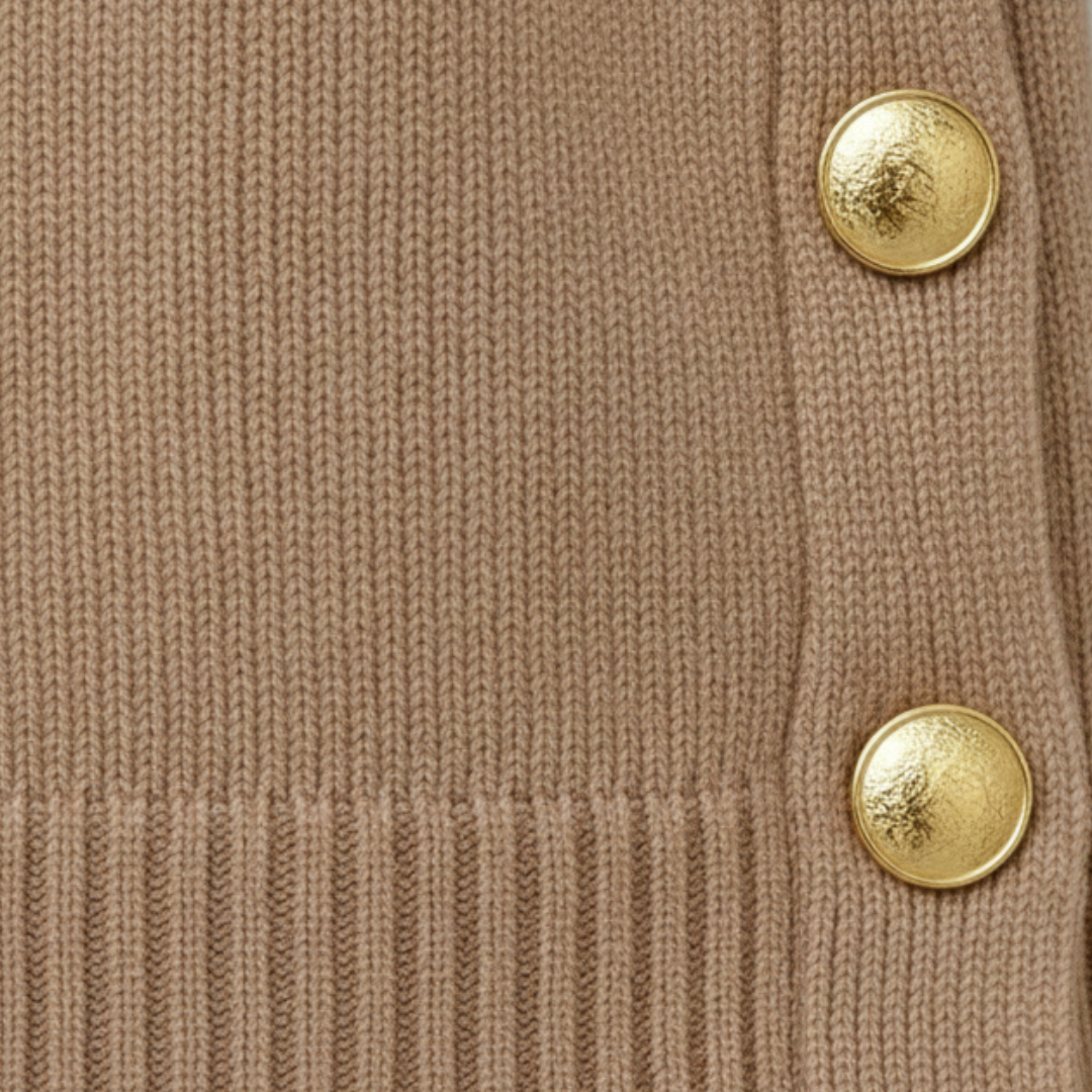 Coordinated beige sweater and pants set featuring gold-tone buttons.