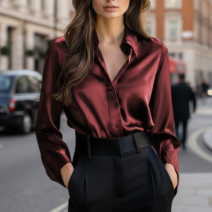 woman dressed in a red satin blouse, highlighting its glossy finish, suitable for various occasions.