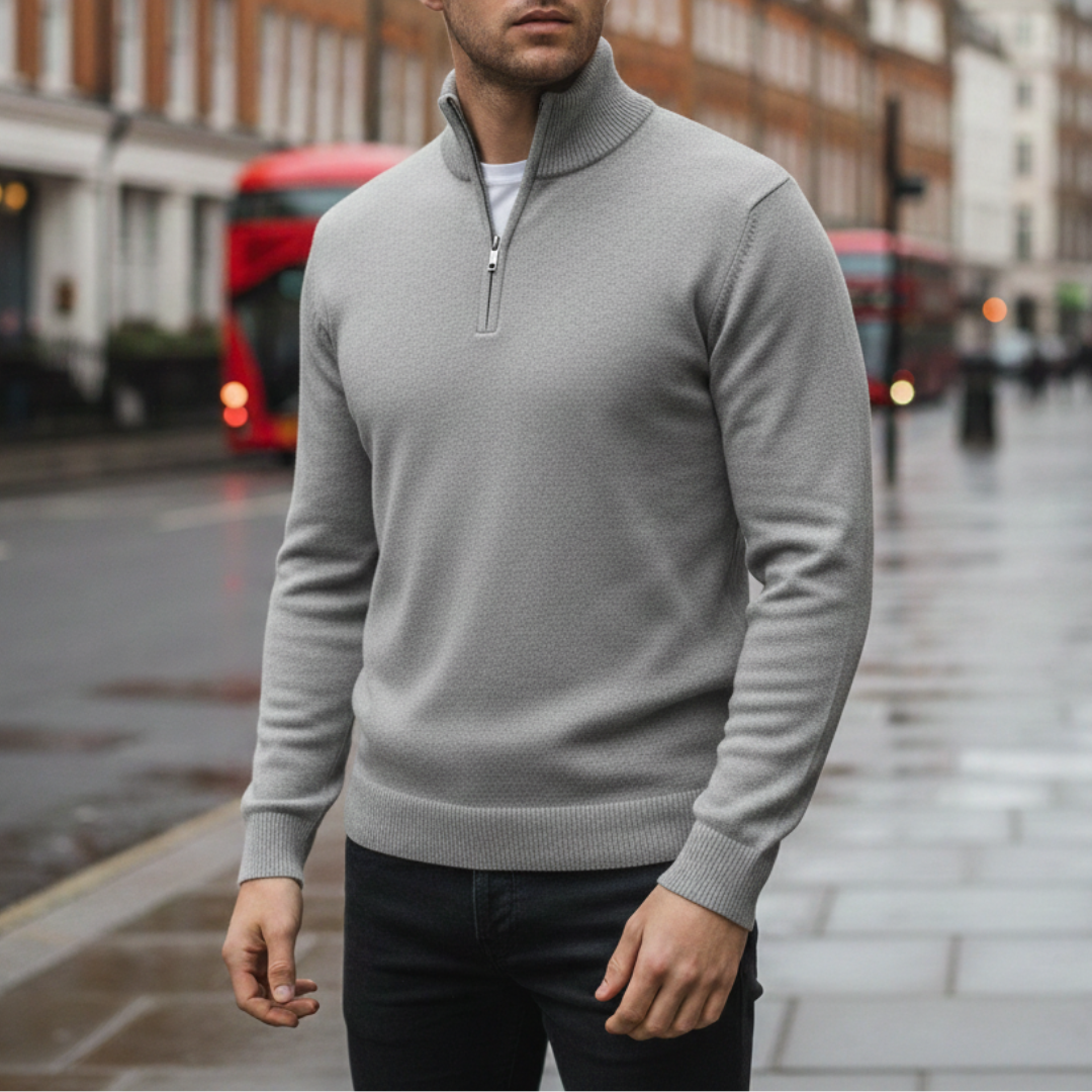 A man wearing a grey half-zip sweater, showcasing a casual style for fall and winter.