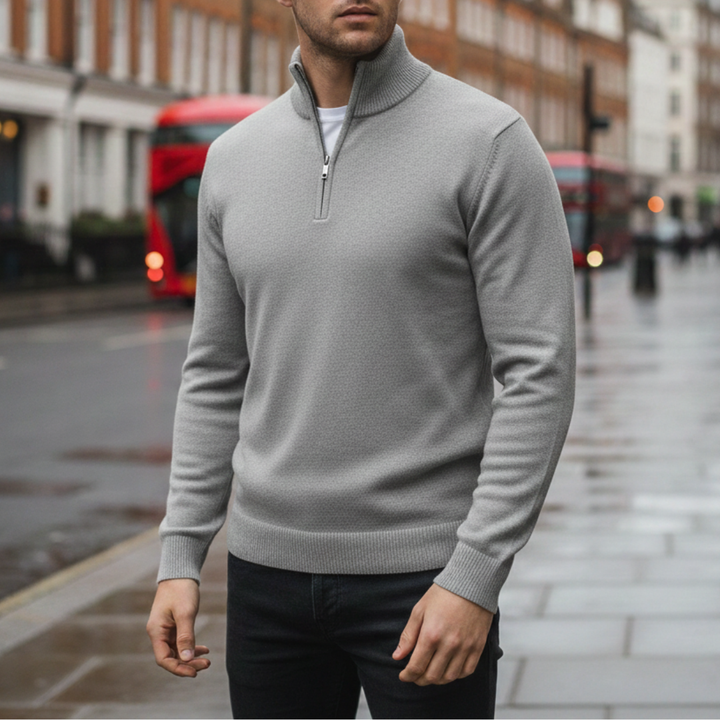 A man wearing a grey half-zip sweater, showcasing a casual style for fall and winter.