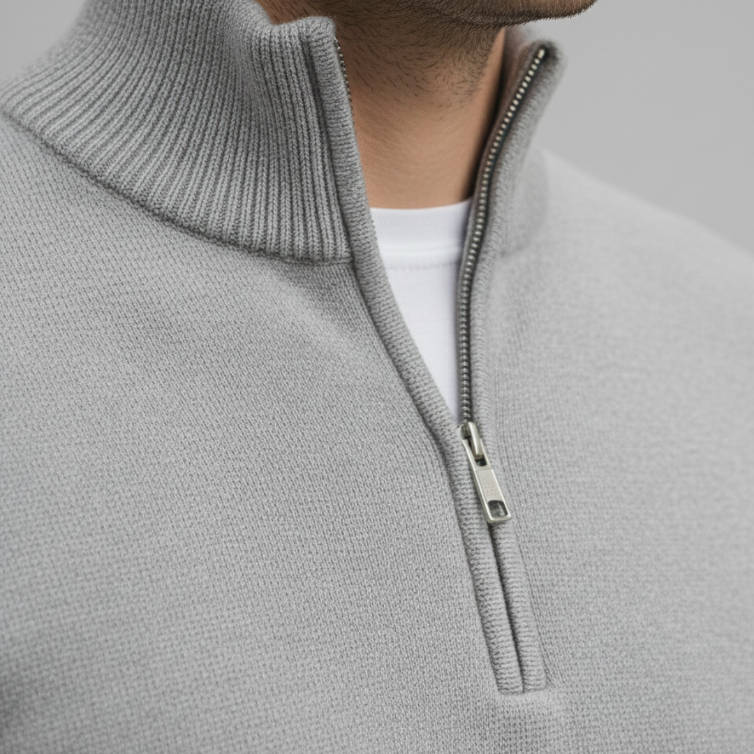 A man wearing a grey half-zip sweater, showcasing a casual style for fall and winter.