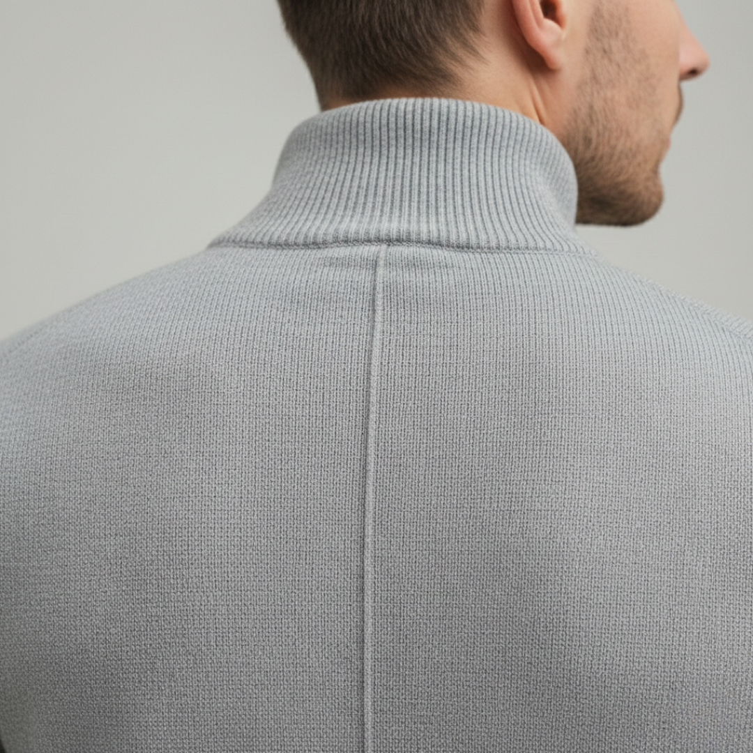 A man wearing a grey half-zip sweater, showcasing a casual style for fall and winter.