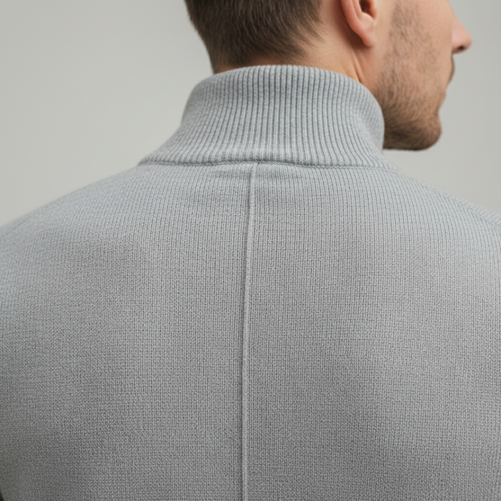 A man wearing a grey half-zip sweater, showcasing a casual style for fall and winter.