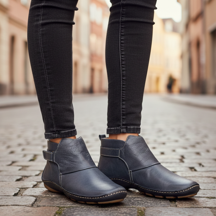  Women's leather ankle boots with buckles, featuring a rounded toe and low heel.