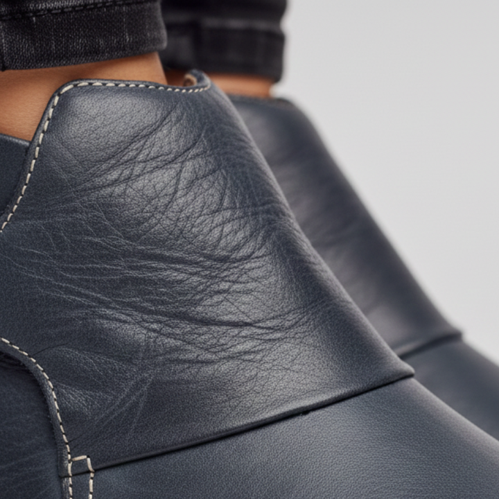  Women's leather ankle boots with buckles, featuring a rounded toe and low heel.