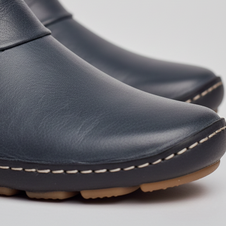  Women's leather ankle boots with buckles, featuring a rounded toe and low heel.