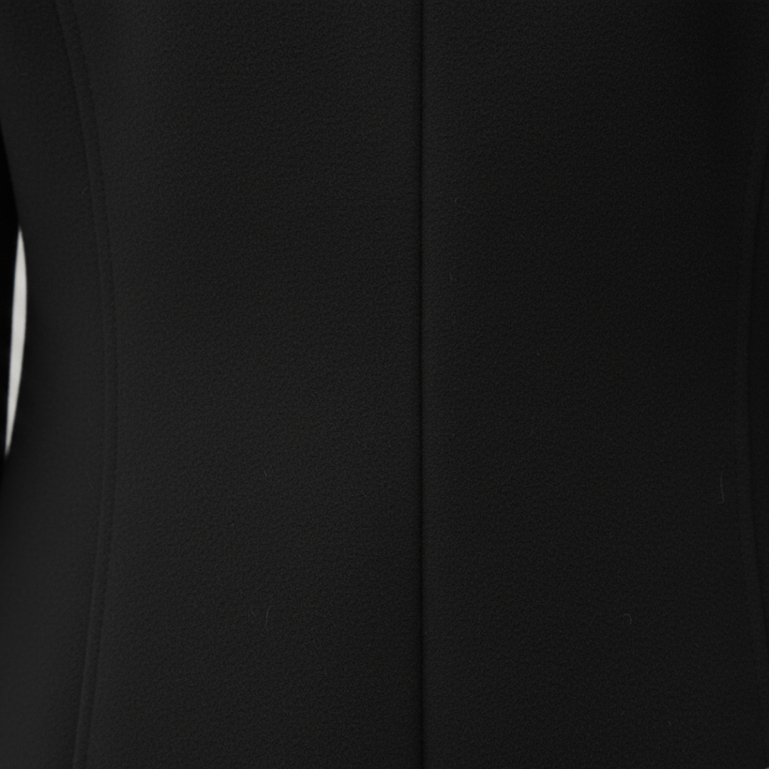 a black tailored coat paired with jeans, good for everyday wear in fall and winter.