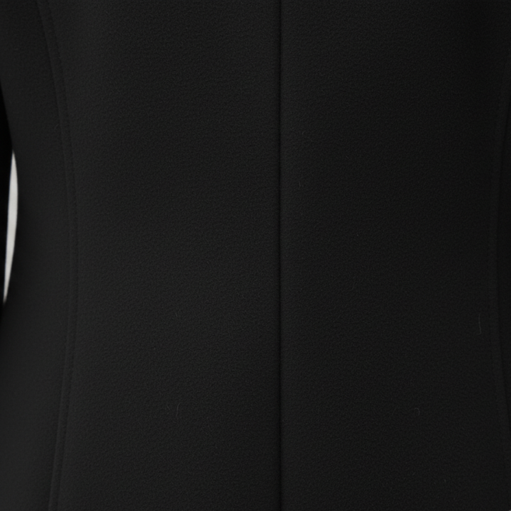 a black tailored coat paired with jeans, good for everyday wear in fall and winter.