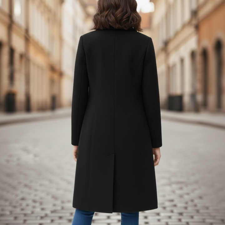 a black tailored coat paired with jeans, good for everyday wear in fall and winter.